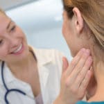 82427241 – doctor checking the lymph nodes size of her patient